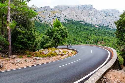 Cyclists riding up the Puig Major peak in Majorca, Spain