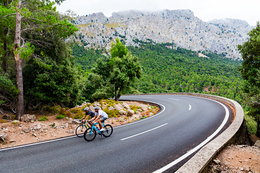 Cyclists riding up the Puig Major peak in Majorca, Spain