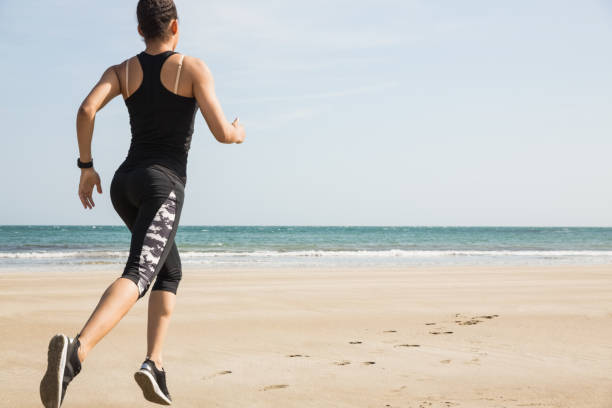 istock Fit woman jogging on the sand 803212866