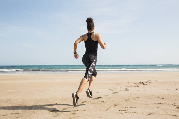 Fit woman jogging on the sand
