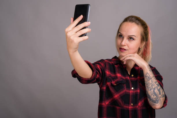 istock Rebel woman vlogging with mobile phone 803220318