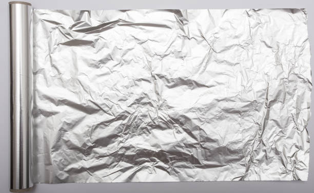 papier aluminium - rolled up foil paper gray photos et images de collection