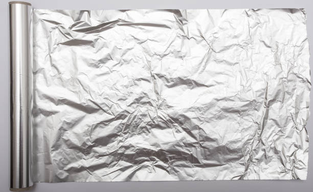 алюминиевая фольга - rolled up foil paper gray стоковые фото и изображения