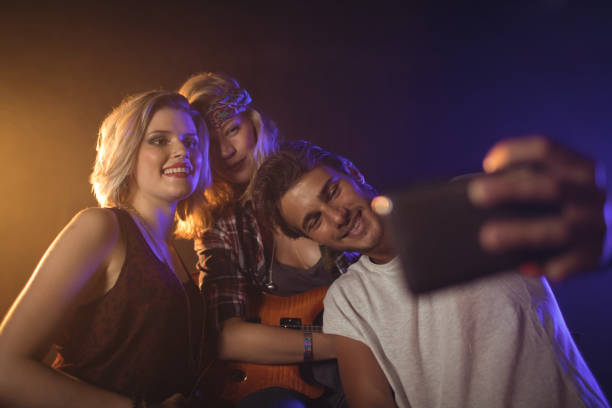 istock Fan taking picture with female performers 803231114