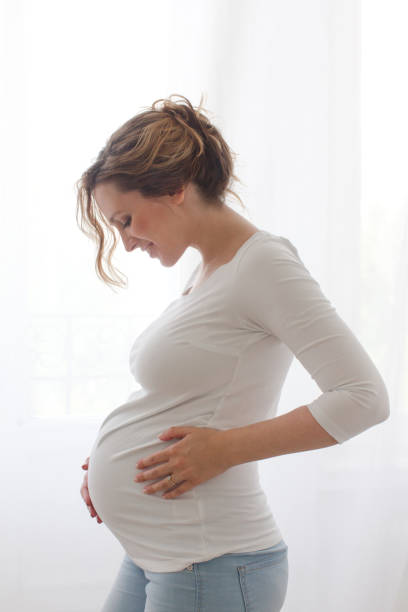 istock Pregnant woman touching belly 803233146