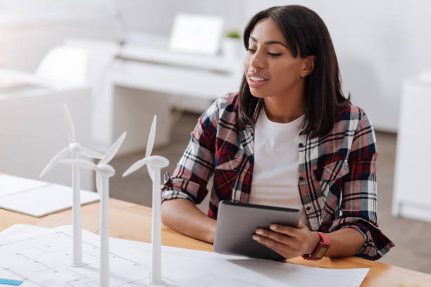 istock Serious smart woman holding a tablet 803235606
