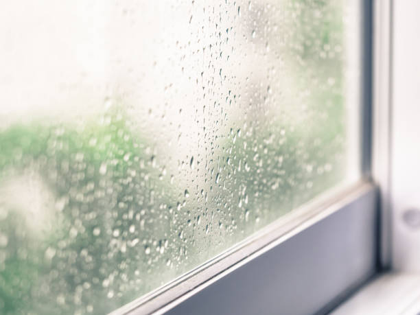 Closeup of rain drops on window glass stock photo