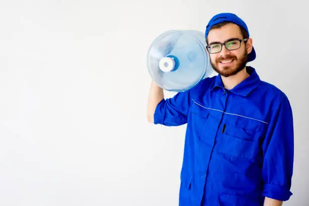 Water delivery service concept: a man with a bottle