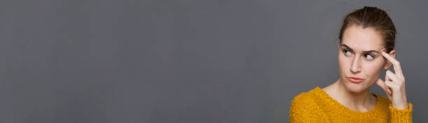 istock annoyed girl in reflection seeking for solutions, copy space banner 803244178