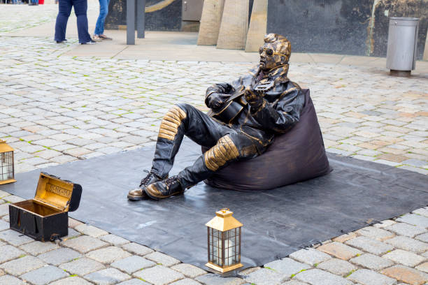 Halifax, Canada - July 29, 2016 - An Elvis impersonator clad in silver clothes and paint stands motionless on the Halifax waterfront.