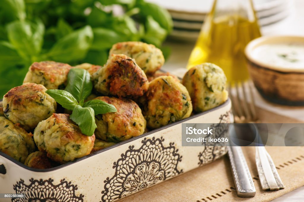 Fried crispy zucchini balls with feta cheese- vegetarian food. Appetizer Stock Photo