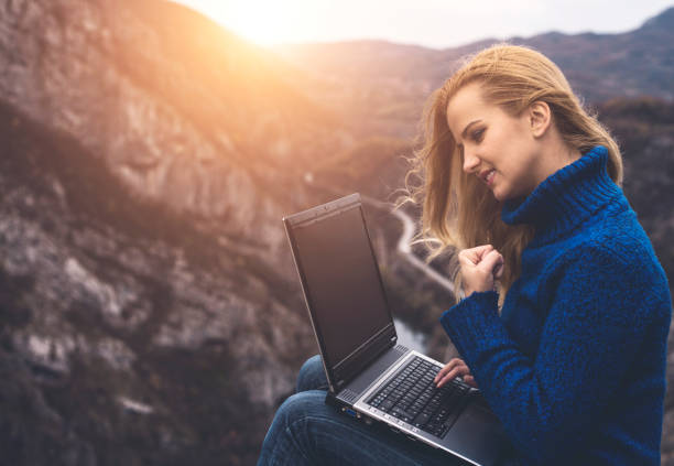 istock Success. Girl using laptop in nature 803260148