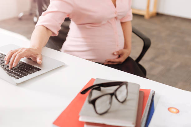 istock Pregnant woman using laptop in the office 803266018