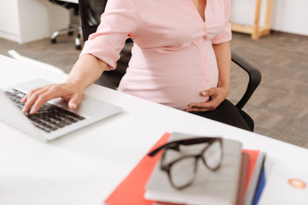 istock Professional pregnant office worker sitting in at the table 803266100