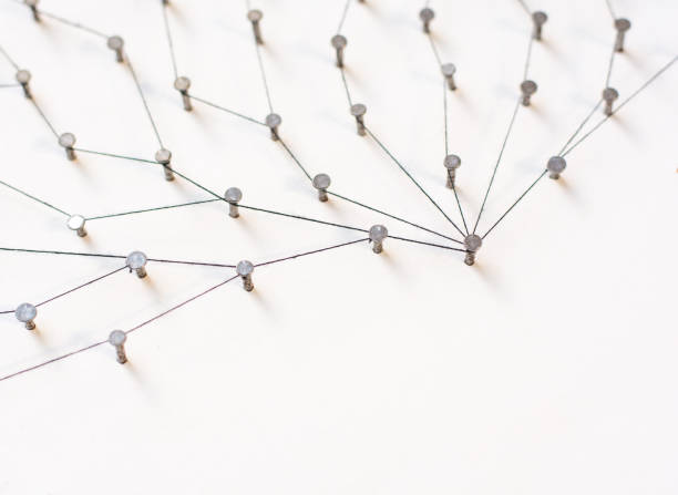 istock Linking entities. Network, networking, social media, internet communication abstract. A small network connected to a larger network. in paper linked together by cotton with a black tint 803270590