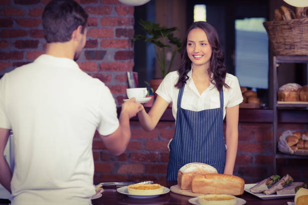 istock Pretty smiling barista serving a customer 803271264