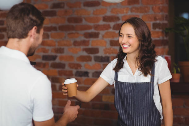 istock Pretty smiling barista serving a customer 803271288