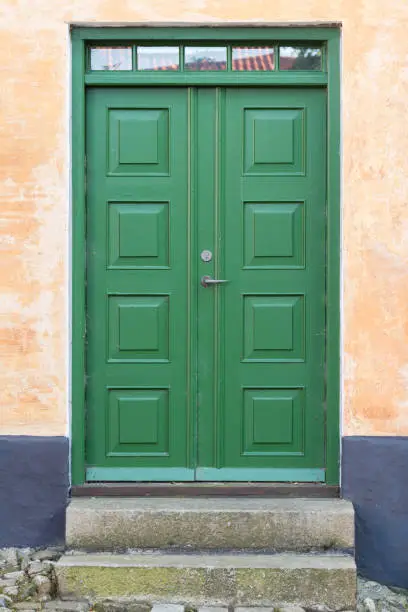 Green double-door (wood) entrance to house, Danish design
