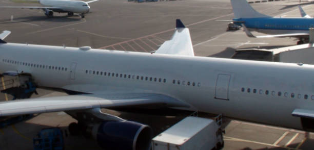 istock Aerial View Of Passenger Airplane Wing,Engine And Window At Airport Loading And Unloading Gate 803277108