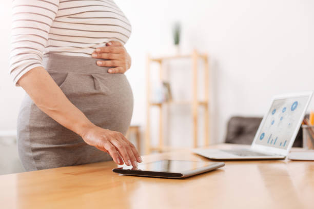 istock Pleasant pregnant woman using a tablet 803284966