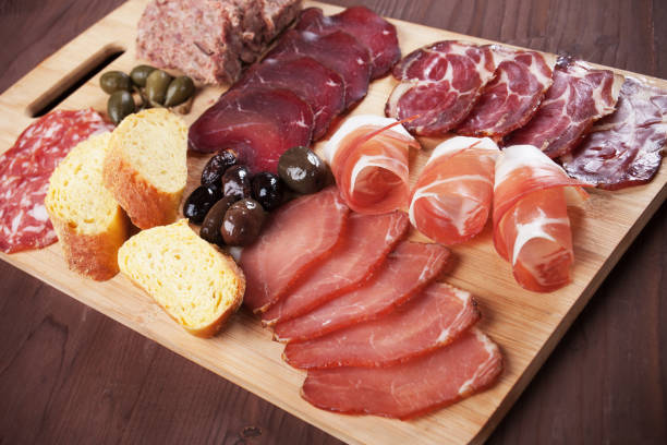 istock Charcuterie board with cured meat and olives 803286812