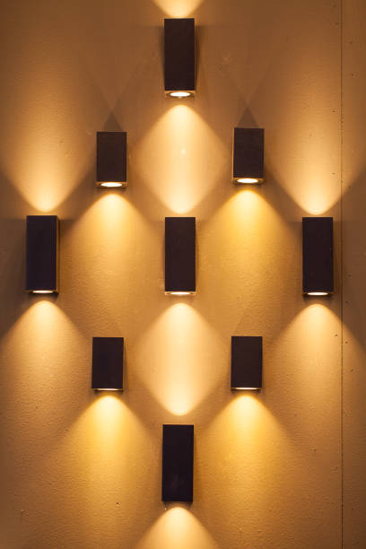 Empty wall with many decorative lamps of orange color