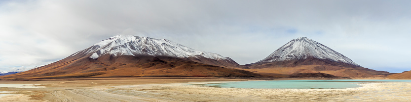 Landscape with two snowy mountains and a light blue lake. Eduardo Abaroa national park, Bolivia