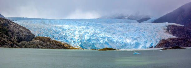 El Brujo Glacier in Asia Fjord, Chile, South America Panoramic view of El Brujo Glacier in Asia Fjord, Southern Patagonia Icefield, Chile, South America. beagle channel photos stock pictures, royalty-free photos & images