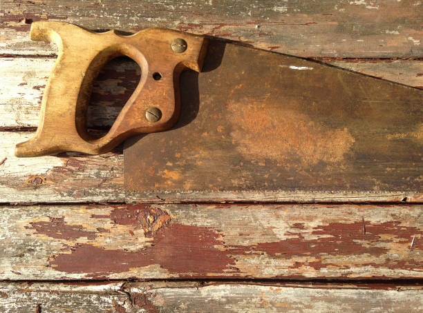Rusty old woodworking tools on a weathered wooden bench background.