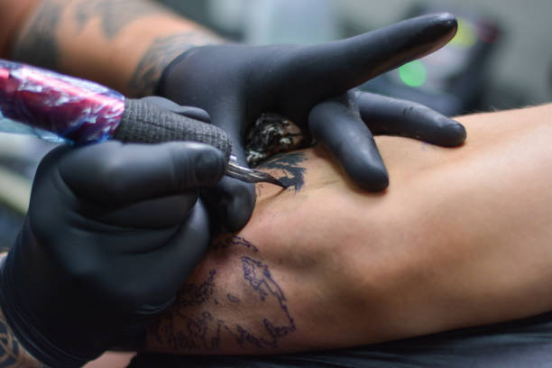 istock Closeup Of Tattoo getting done on male arm 803304098