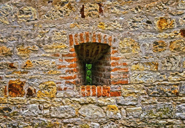 Window or loophole in the ancient wall built of irregular stones.