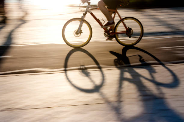 istock Blurry cyclist silhouette and shadow on a  bike lane 803311376