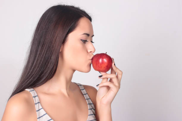 istock Young caucasian woman holding apple 803318228