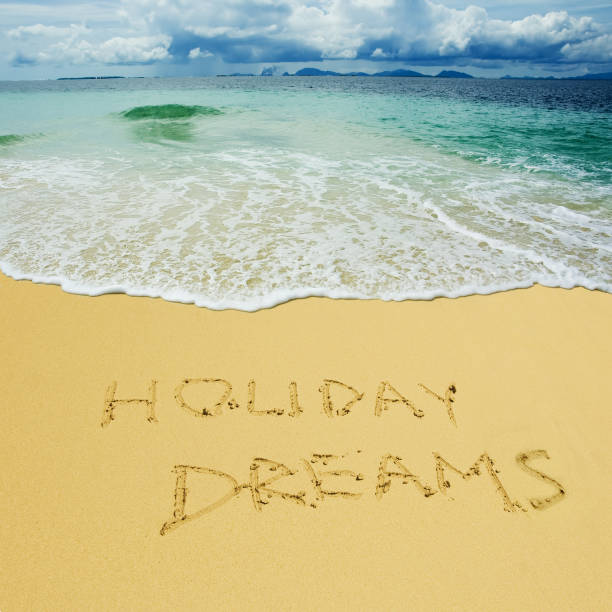 istock holiday dreams written in a sandy tropical beach 803322438