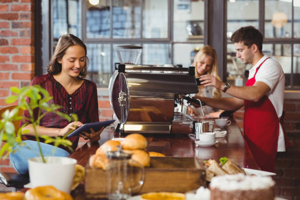 istock Handsome barista preparing a cup of coffee 803322534