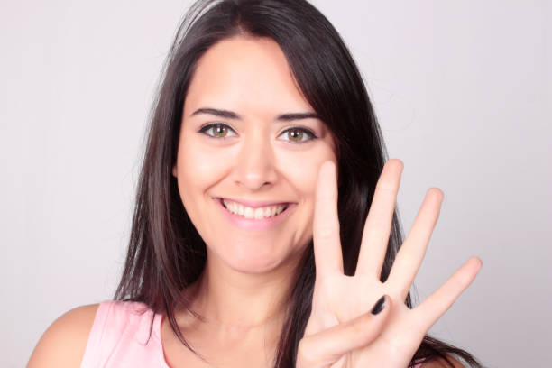 istock Young woman counting four with her fingers. 803323432