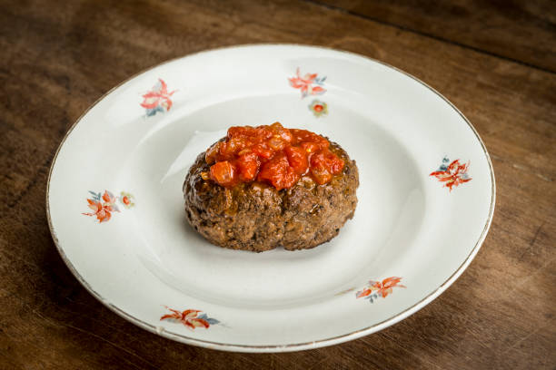 View of a polpetone and tomato sauce served on an old-fashioned plate