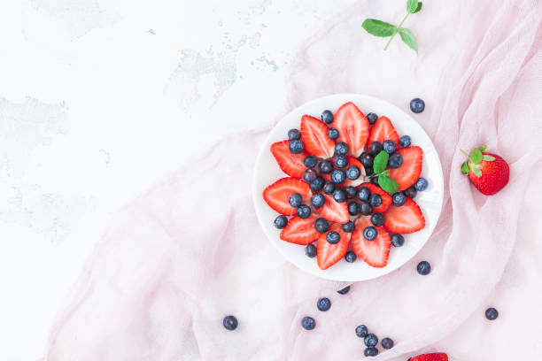 istock Fruit salad with strawberry and blueberry.  Flat lay, top view 803326526