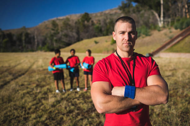 istock Trainer standing with arms crossed in the boot camp 803331702