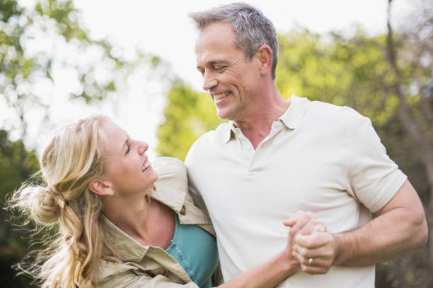 istock Cute couple dancing and holding hands 803331956