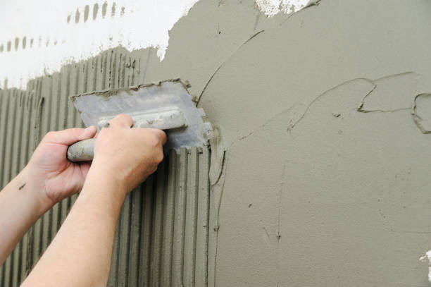 istock Tilers hands are putting an adhesive. 803340158