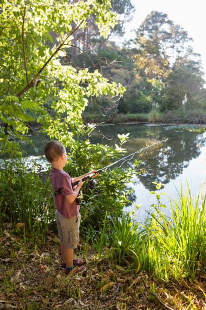 istock Boy fishing in the river 803352972