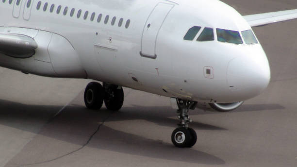 istock Close Up View Of Passenger Airplane Taxiing To Loading,Unloading Gate For Disembarkation After Arrival 803363298