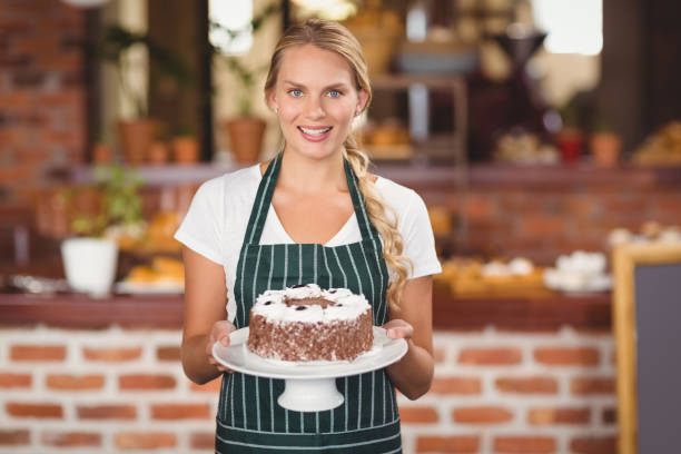 istock Pretty waitress holding a chocolate cake 803374730