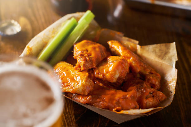 istock beer and hot buffalo chicken wings in tray with celery 803384764