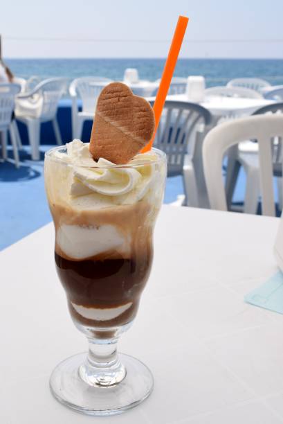 Glass with ice cream and coffee on a coffee table at a bar near the sea