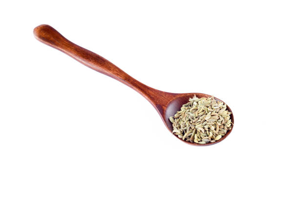 istock Aniseed Spice in wooden spoon over white background 803391964