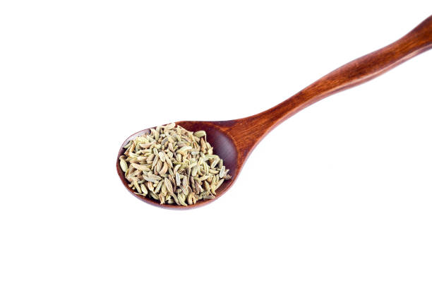 istock Aniseed Spice in wooden spoon over white background 803392158