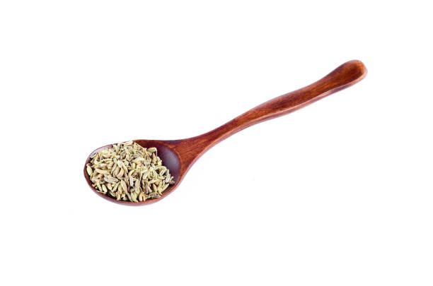 istock Aniseed Spice in wooden spoon over white background 803392238