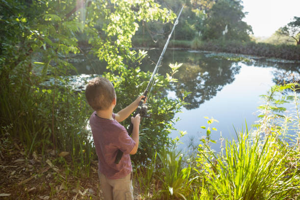 istock Boy fishing in the river 803394732